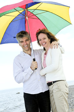 Happy Mature Couple With Umbrella