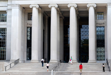 students on steps of university building with columns