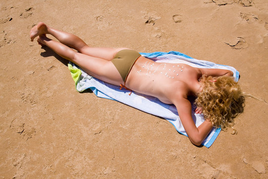 a beautiful woman suntanning on the beach