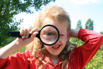 Young observer with lens