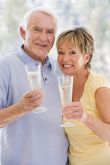 Couple toasting champagne and smiling