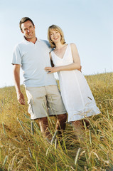 Couple standing outdoors smiling