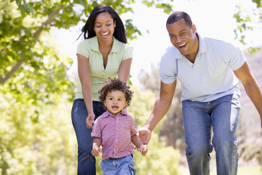 Family Running Outdoors Smiling