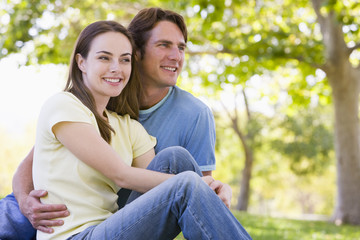 Fototapeta na wymiar Couple sitting outdoors smiling