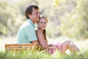 Couple at park having a picnic and smiling