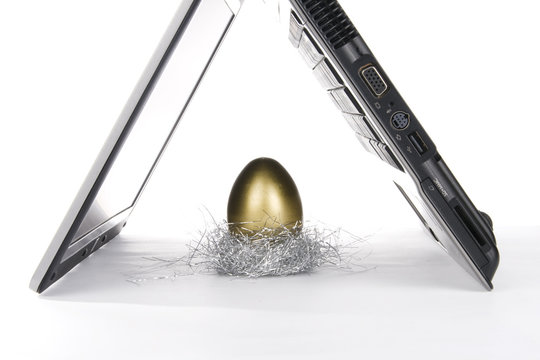 laptop and golden egg - Powered by Adobe