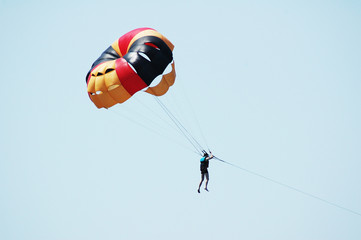 Multi coloured parachute over the blue sky