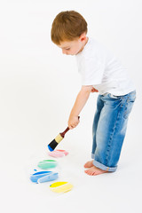 Child painting with primary colors