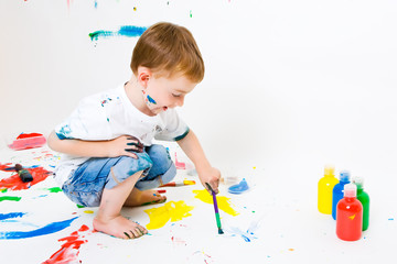 Child painting on the floor