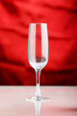 Empty wine glass against the red background