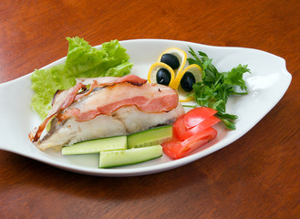 halibut prepared with vegetables and bacon