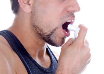 man with pump in his mouth, against asthma
