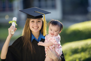 Young woman graduate holding baby