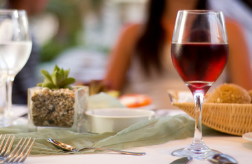 The served table with red wine at restaurant (shallow dof)