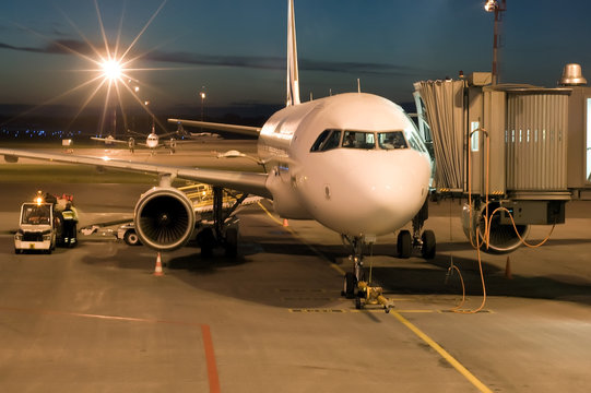 Fototapeta plane parked at the airport at night