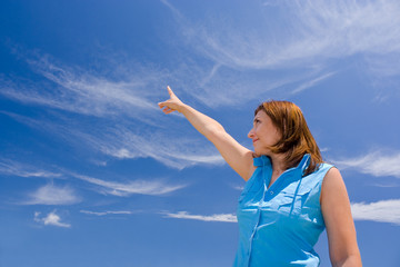 Young woman pointing to the sky