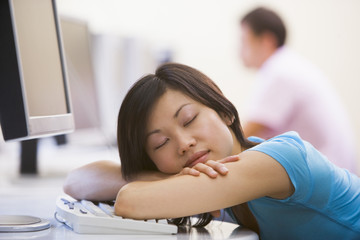 Obraz na płótnie Canvas Woman in computer room sleeping