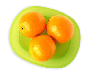 oranges on a green plate