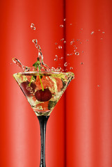 view of  martini glass with vermouth and cherry dropping in