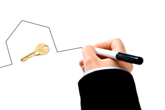 businesswoman drawing house around keys - real state concept