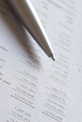 Ballpoint pen on financial figures
