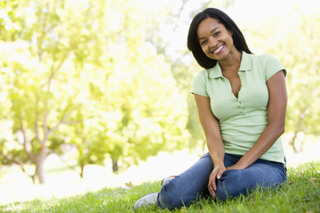 Woman sitting outdoors smiling