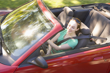 Woman in convertible car smiling