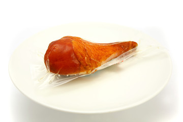 turkey leg inside vacuum on dish