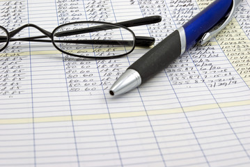 Ledger with pen and glasses