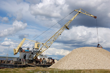 The port dredge unloads sand from the barge