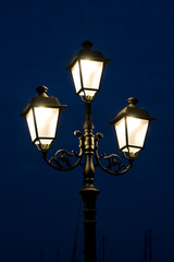 Fototapeta na wymiar Old, stylish multi-branch steret lamp