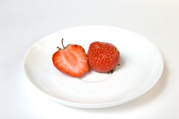 Ripe strawberries in a plate, isolated on white