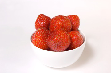 Fresh and tasty strawberries in a plate, isolated on white