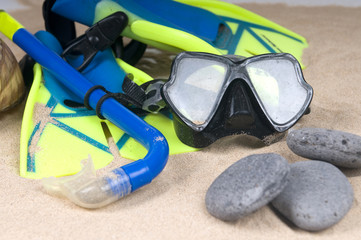 mask, fins and tube in sand background