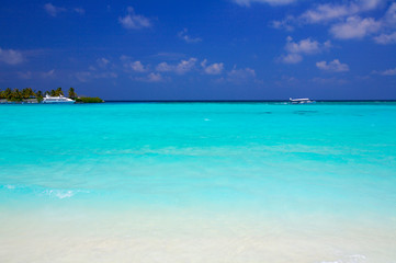 Sand beach and ocean vessels, Ari-Atoll. Maldives