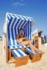 Bikini girl lying in a roofed wicker beach chair 314