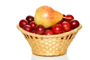 basket with cherry plums and pear isolated on the white