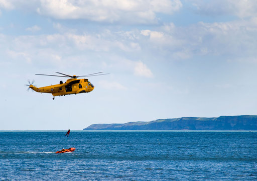 Air sea rescue helicopter lifts winchman from lifeboat