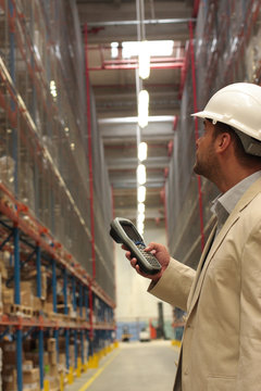 An inspector with bar code reader counting stock