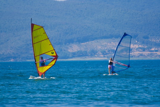 Sailing windsurfers Bracciano lake Italy