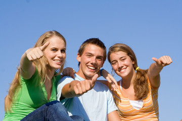 happy smiling group of teens with thumbs up