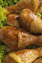 some roasted chicken legs over lettuce