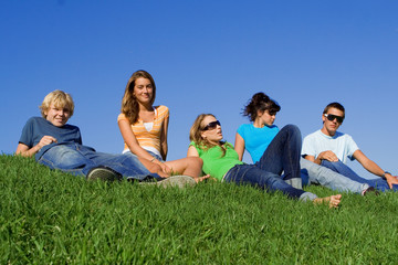group of happy youth chilling out at summer camp