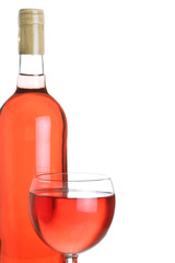 bottle and glass of fruity rose wine, backlit