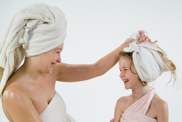 Young woman and little girl after the bath