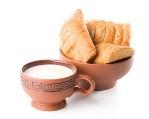 Appetizing pie and cup of milk on a white background