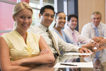 Fototapeta premium Five businesspeople at boardroom table smiling