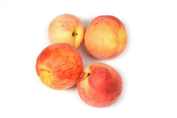 Four fresh tasty peaches on white background