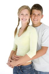 Fototapeta premium Young couple standing together smiling