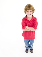 Young boy with arms crossed smiling